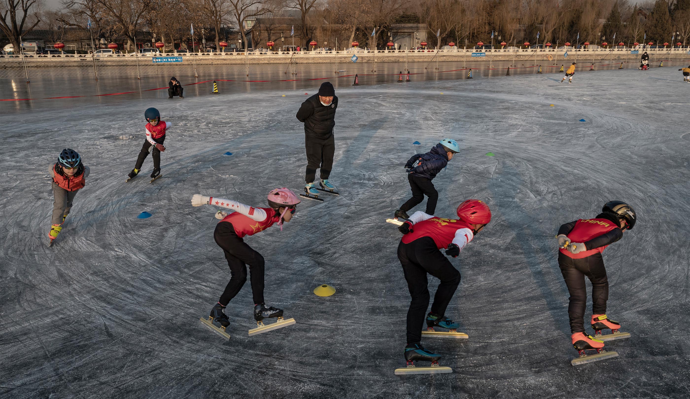 Young speed skaters train on the ice at an outdoor rink on Shichahai Lake at Houhai