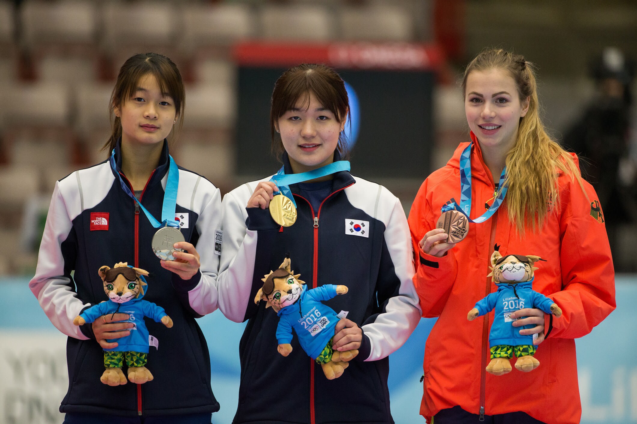 Korea's Kim Jiyoo (centre) with her gold medal, flanked by compatriot Lee Suyoun (left, silver) and Germany's Anna Seidel (right, bronze) after the ladies' short track speed skating 1000m final. Photo: YIS / IOC Al Tielemans