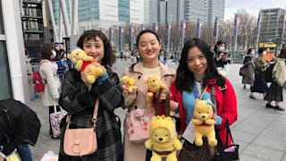 Yuzuru Hanyu fans pose with Pooh toys at the World Figure Skating Championships