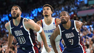 Jayson Tatum and Kevin Durant of the USA box out Victor Wembanyama (centre) of France