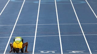 Usain Bolt celebrates winning the Men's 200m Final by kissing the track on Day 13 of the Rio 2016 Olympic Games. 