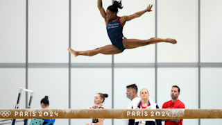 Simone Biles practices on the balance beam during a gymnastics training session ahead of the Olympics