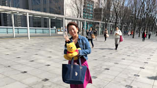A Yuzuru Hanyu fan poses with a Pooh toy at the World Figure Skating Championships