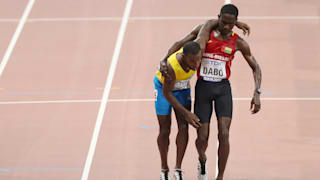 Braima Suncar Dabo helps Jonathan Busby to the finish line in their 5000m heat in Doha
