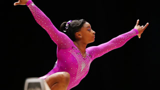 Simone Biles poses during the beam final at the 2015 Worlds