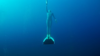 Alice Modolo, world-medallist in free-diving, with the Olympic Torch in the Mediterranean See in Villefranche-sur-Mer during the stage 34