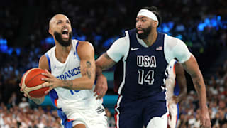 Evan Fournier #10 of Team France drives past Anthony Davis #14 of Team United States