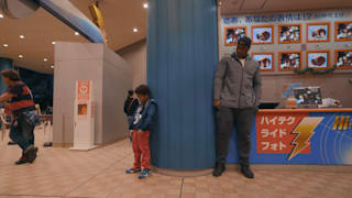 Riner playing with his son Eden in the Tokyo metro station Credit: FranceTV Studio