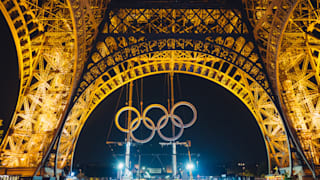 Olympic rings during their installation the Eiffel Tower