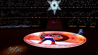 The Paralympic flame is seen inside the stadium as performers look on during the Closing Ceremony
