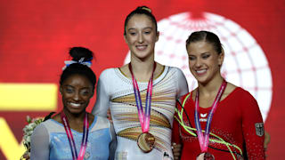 Simone Biles (left), Nina Derwael (center) and Elisabeth Seitz (right) share the uneven bars podium at the 2018 Worlds