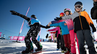 An athlete high fives spectators whilst training for the Snowboarding Halfpipe event in the Leysin Park Halfpipe ahead of competition at The Winter Youth Olympic Games, Lausanne, Switzerland, Thursday 16 January 2020. Photo: OIS/Simon Bruty. 