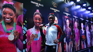 Triple vision: Simone Biles poses in the Glasgow 'Walk of Champions' after taking third World all-around title