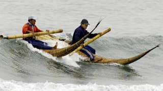 Two fishermen riding atop "reed horses", special cigar shaped, wave-breaking boats believed to have been used for more than 1,500 years, paddle their way back to the beach with their catch, January 28, 2001. The hollow kayaks, with their characteristic pointed prows rising out of the water, are believed to have been used by the ancient inhabitants of northern Peru to ply the choppy Pacific. They are similar to the boats depicted on ceramics from Peru's Moche civilization 1,500 years ago. The inhabitants of Huanchaco are among the few remaining people on the coast who still know how to build and pilot these precarious-looking craft.
