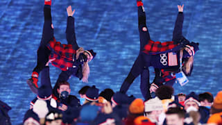 Members of Team USA react as they make their way around the Beijing National Stadium 