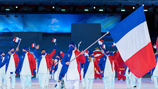 Benjamin Daviet carries the flag for the France team during the opening ceremony of the Beijing 2022 Winter Paralympic Games