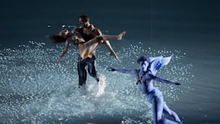 Two performers dance as a performer representing Eros, Archer of Love, from Greek mythology flies overhead during the opening ceremony of the Athens 2004 Summer Olympic Games.