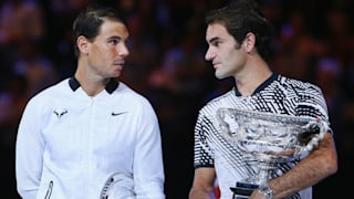 Roger Federer of Switzerland (R) celebrates with the Trophy after winning against Raphael Nadal of Spain in the Men's Final match against on day 14 of the 2017 Australian Open