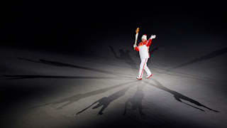 A torchbearer carries the Paralympic torch during the Opening Ceremony of the Beijing 2022 Winter Paralympics