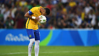 Neymar of Brazil kisses the ball as he prepares to take the winning penalty in the penalty shoot out during the Men's Football Final between Brazil and Germany at the Maracana Stadium.