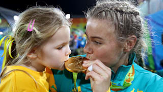 Nicole Beck of Australia kisses her Gold medal with her daughter Sophie Beck after the medal ceremony for the Women's Rugby Sevens on Day 3 of the Rio 2016 Olympic Games.