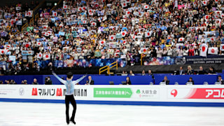 Yuzuru Hanyu waves to the crowd after his short program at the 2019 Worlds