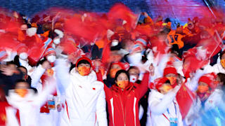 Members of Team China wave flags as they walk in the Athletes Parade during the Beijing 2022 Winter Olympics Closing Ceremony