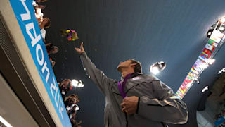 Michael Phelps throws his ceremonial flowers to his mother Debbie Phelps following the medal ceremony for the Men's 4x100m medley Relay Final on Day 8 of the London 2012 Olympic Games.