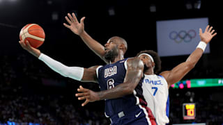 Lebron James #6 of Team United States drives past Guerschon Yabusele #7 of Team France