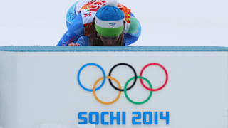 Tina Maze of Slovenia kisses the podium in celebration during the flower ceremony for the Alpine Skiing Women's Giant Slalom on day 11 of the Sochi 2014 Winter Olympics.