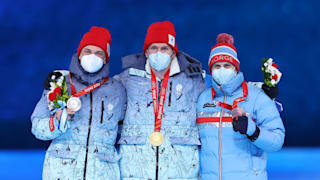 Gold medallist Alexander Bolshunov (C), Silver medallist Ivan Yakimushkin (L) and Bronze medallist Simen Hegstad Krueger (R) 