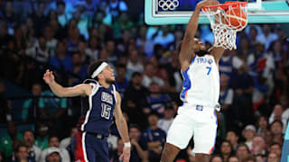 Guerschon Yabusele #7 of Team France dunks the ball over Devin Booker #15 of Team United States