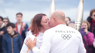 Two torchbearers kiss