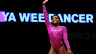 Simone Biles waves after her performance in the floor final at the 2015 Worlds