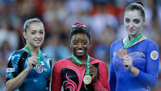 Larisa Iorache (left), Simone Biles (middle) and Aliya Mustafina (right) pose with their medals after the floor exercise final at the 2014 Worlds