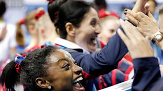 Simone Biles smiles after winning team gold in 2014