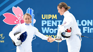 Laura Asadauskaite (L) shakes hands with Elodie Clouvel after their Fencing bout