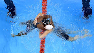 Simone Manuel of the United States (L) embraces Penny Oleksiak of Canada after winning gold in the Women's 100m Freestyle Final on Day 6 of the Rio 2016 Olympic Games.