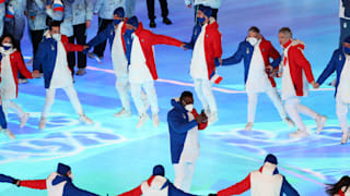 Members of Team France make their way around the Beijing National Stadium 