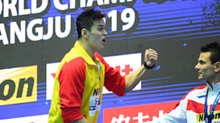 Sun Yang (L) of China shakes hands with bronze medallist Martin Malyutin of Russia while yelling at Duncan Scott (not pictured) of Great Britain during the medal ceremony for the Men's 200m Freestyle Final on day three of the Gwangju 2019 FINA World Championships at Nambu International Aquatics Centre on July 23, 2019 in Gwangju, South Korea. (Photo by Quinn Rooney/Getty Images)