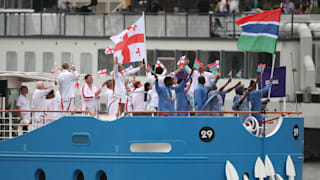  Team Gambia and Team Georgia arrive on a colorful boat