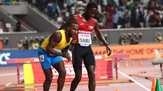 Braima Suncar Dabo helps Jonathan Busby in their 5000m heat on day one of the 2019 IAAF World Championships in Doha