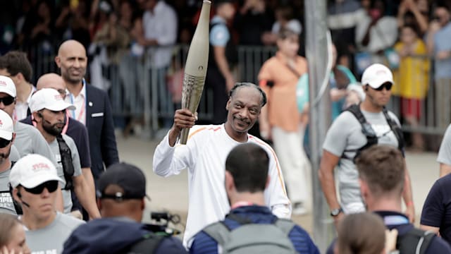 American rapper Snoop Dogg lighting up the Olympic Torch Relay