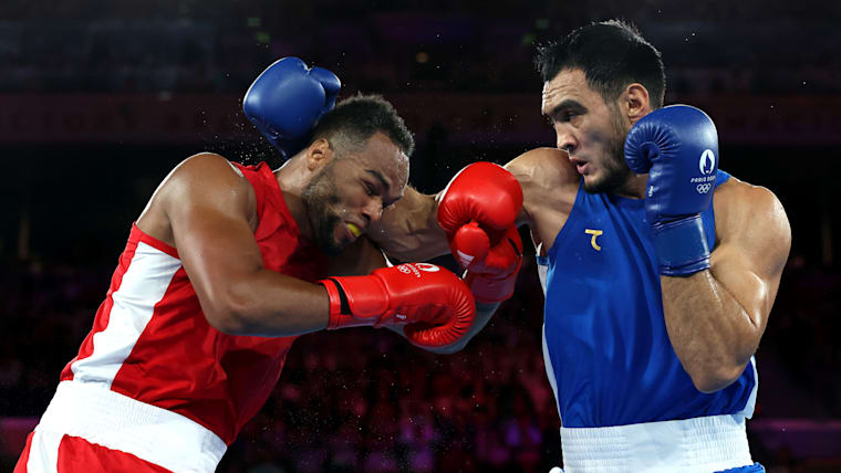 Loren Berto Alfonso Dominguez of Azerbaijan and Lazizbek Mullojonov of Uzbekistan in Olympic men's boxing 92kg gold medal match