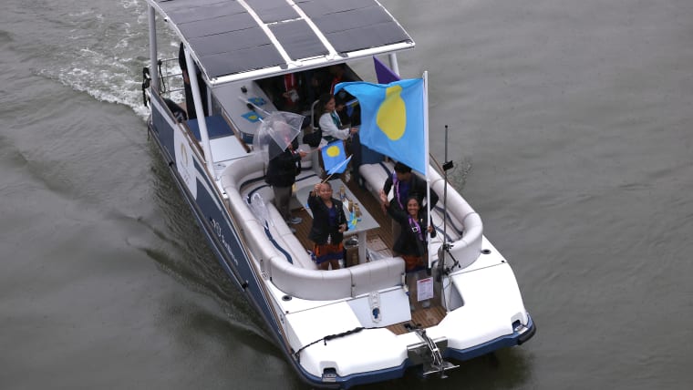 GettyImages-216384310Athletes from Palau wave flags during the Opening Ceremony of the Olympic Games Paris 2024