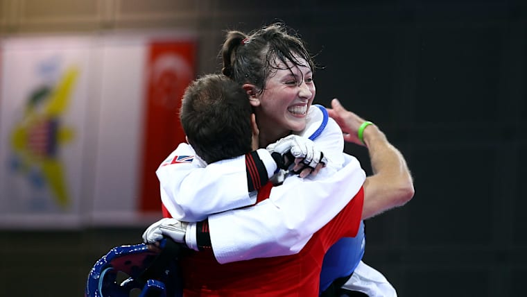 Jade Jones of Great Britain celebrates with her coach after defeating Thanh Thao Nguyen of Vietnam in the gold medal match in the 55kg Taekwondo final at the Singapore 2010 Youth Olympic Games 