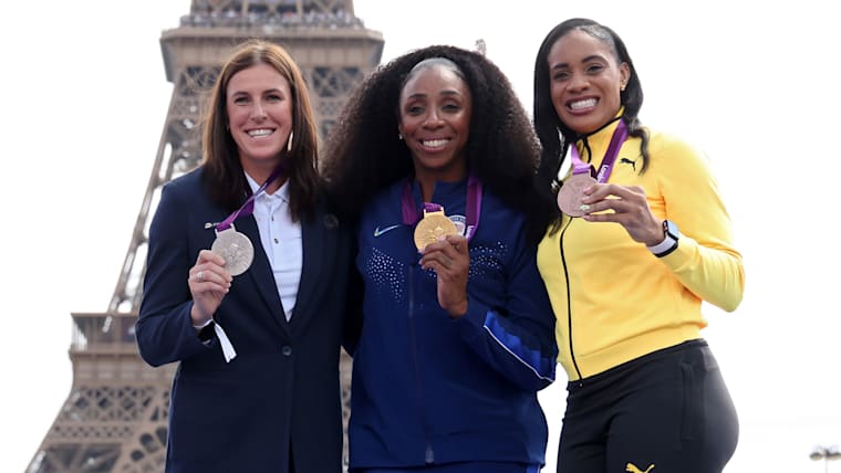 Zuzana Hejnova of Czechia, Lashinda Demus of the United States, and Kaliese Spencer of Jamaica are awarded silver, gold, and bronze medals for the women's 400m hurdles from the 2012 London Olympics during a medal reallocation ceremony on day fourteen of the Olympic Games Paris 2024 at Champions Park on August 09, 2024 in Paris, France.