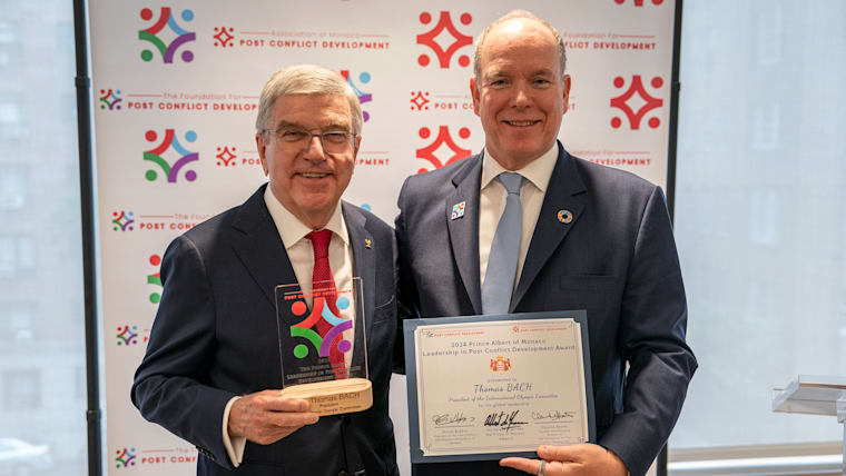 IOC President Thomas Bach is presented the Post Conflict Development Foundation Award at the Mission of Monaco in New York