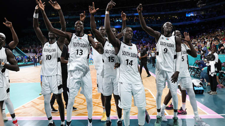 South Sudan's men's basketball team celebrate their Olympic debut win over Puerto Rico at Paris 2024.