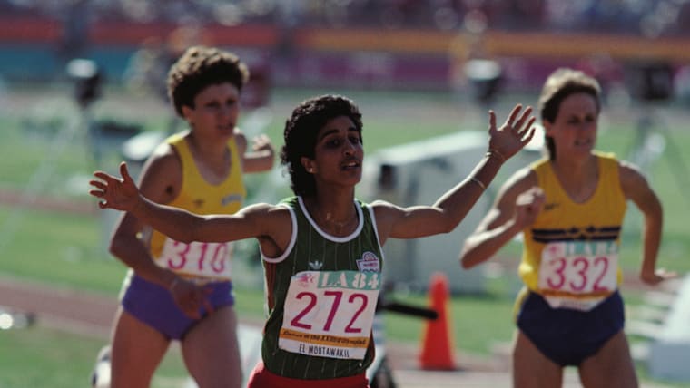 Nawal El Moutawakel of Morocco celebrates her gold medal for winning the inaugural Women's 400 metres hurdles event at the XXIII Olympic Summer Games on 8th August 1984 at the Los Angeles Memorial Coliseum.